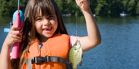 Little girl with fish on the line
